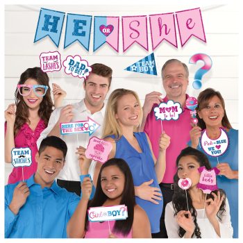 Group celebrating with gender reveal signs.