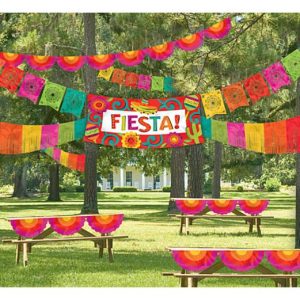 Colorful fiesta decorations in a park setting.