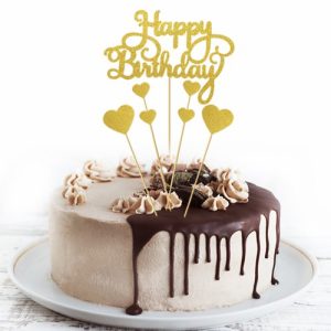 Birthday cake with chocolate drip and topper.