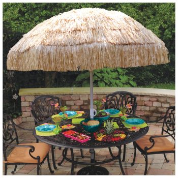 Outdoor table with umbrella and tropical decor.