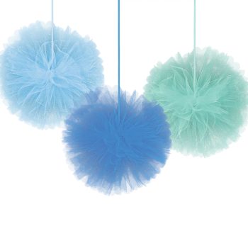 Three fluffy pom-poms in pastel blue, green, and dark blue hanging by strings.