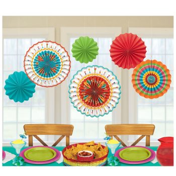 Colorful paper fans hanging above a vibrant table setting.