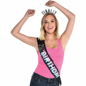 Woman celebrating birthday with sash and tiara.