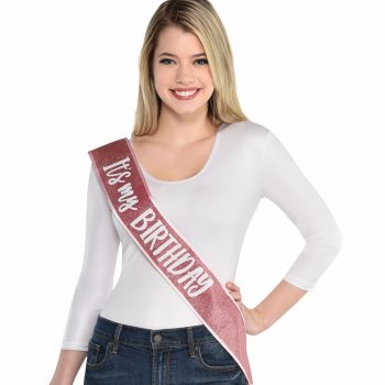 Woman wearing "It's my BIRTHDAY" sash.