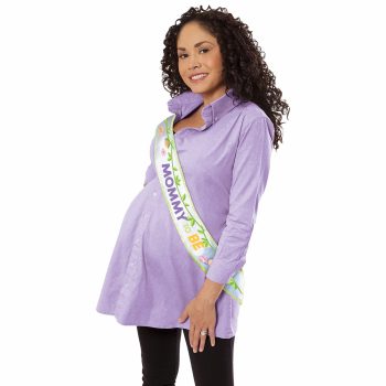 Pregnant woman wearing a purple sweater and a 'Mom-to-Be' sash.
