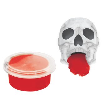 Skull with red tongue beside red container.