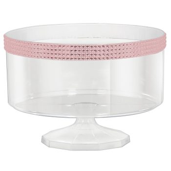 Clear cake stand with pink decorative band.