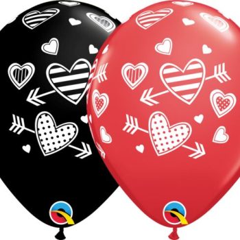 Two balloons, one black and one red, decorated with white heart designs.
