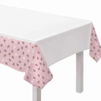 White table with pink patterned tablecloth.