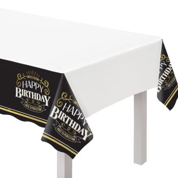 White table with birthday-themed tablecloth.