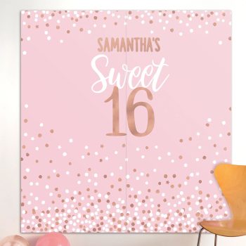 Pink "Sweet 16" party backdrop with decorations.