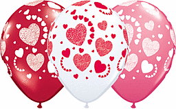 White balloon with red hearts surrounded by red and pink balloons.