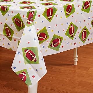 Festive tablecloth with Christmas-themed patterns on a wooden table.
