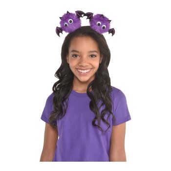 Girl wearing purple bat headband, smiling.