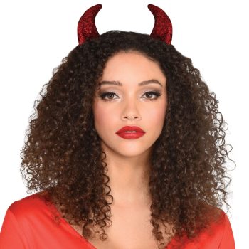 Woman wearing red devil horns, curly hair.