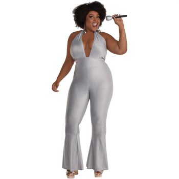 Woman in silver jumpsuit holding microphone.
