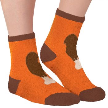Orange socks with brown dog design worn.