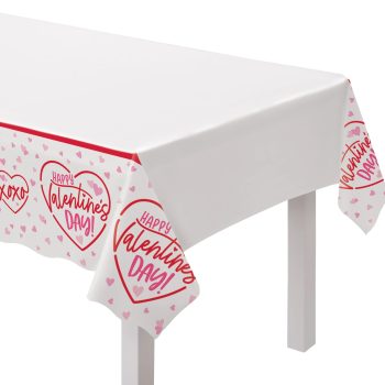 White tablecloth with red heart-shaped Valentine's Day designs along the edges.