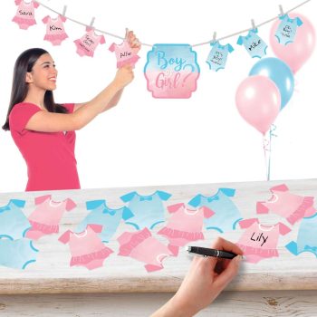 A woman hanging pink and blue baby clothes for a gender reveal party.