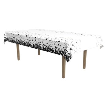 A table covered with a white and black speckled tablecloth.