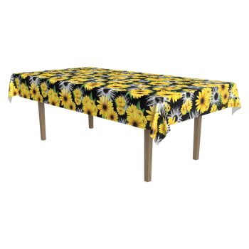 Rectangular table covered with a sunflower-patterned tablecloth.