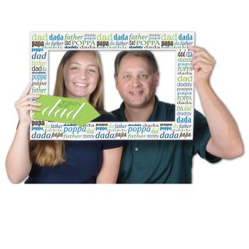 Two people holding a decorated photo frame with smiling faces inside.