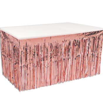 Table decorated with shiny pink fringe skirt for party.
