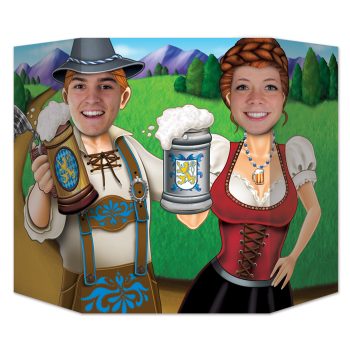 A cheerful man and woman in traditional Bavarian attire raising beer steins outdoors.