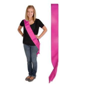 Young woman wearing a bright pink sash and casual outfit.