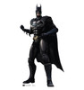 Batman standing in iconic black suit with cape and mask.