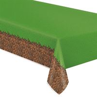 Tablecloth with grass and soil design draping over a table corner.