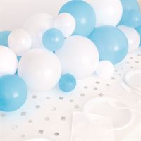 Blue and white balloons with star-patterned tablecloth for celebration.