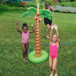 Two children playing with a water sprinkler shaped like a palm tree.